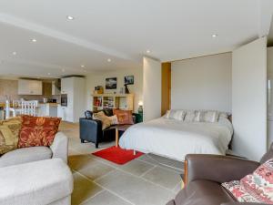 a bedroom with a bed and a living room with a couch at 1 Bed in Hathersage 78016 in Bradwell