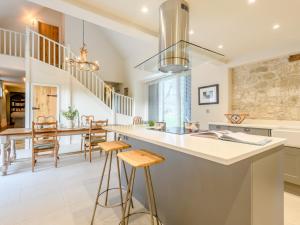 a kitchen with a large island with bar stools at 2 Bed in Tisbury 78165 in Tisbury