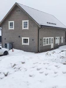 a house with a lot of snow in front of it at Stuga i Branäs Byn in Sysslebäck