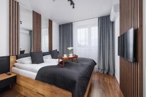 Posteľ alebo postele v izbe v ubytovaní Near EXPO Cracow Elegant Apartment by Noclegi Renters