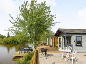 a house with a deck next to a river at 1 Bed in Ludlow 87474 in Ashford Carbonell