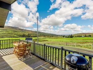 a patio with a table and a grill on a deck at 2 Bed in Portree 87578 in Portree