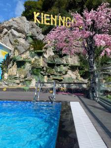 a swimming pool at a resort with a sign that reads karma at KIÊN NGỌC VILLA Cat Ba in Cat Ba +6 photos