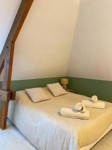 a bedroom with a bed with two towels on it at La Boussole in Étretat