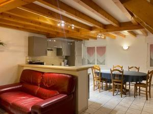 a living room with a couch and a kitchen and a table at La Boussole in Étretat
