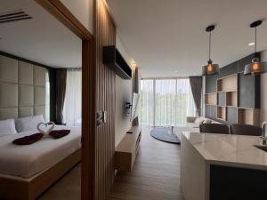 a hotel room with a bed and a kitchen at Luxury Resort Rawai in Rawai Beach