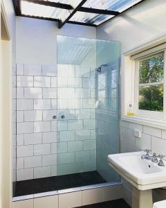a bathroom with a glass shower and a sink at Myrtlemae Farm in Balingup