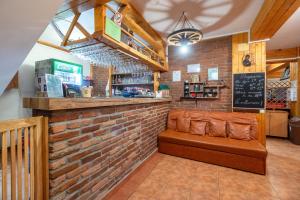 a bar in a restaurant with a brick wall at Resort 7 Crai - Cabana Craiul Crailor in Zărneşti