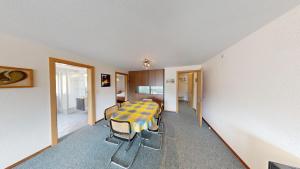 a room with a table and chairs in a room at Floralpina FL1 in Blatten bei Naters