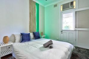a bedroom with a bed with blue and green walls at Gorgeous 2 Bedroom House Ultimo 2 E-Bikes Included in Sydney