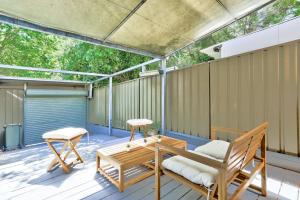 a patio with a table and chairs on a deck at Gorgeous 2 Bedroom House Ultimo 2 E-Bikes Included in Sydney