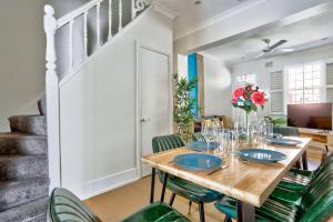 a dining room with a wooden table and green chairs at Gorgeous 2 Bedroom House Ultimo 2 E-Bikes Included in Sydney