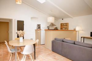 a living room with a couch and a table at Le Domaine de L'Osage in Pont-Saint-Esprit