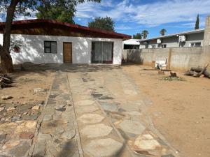 a house with a stone walkway in front of it at De la posh Travels and tours in Windhoek