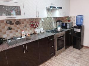a kitchen with a sink and a stove at Family guest house SEVEN in Samarkand