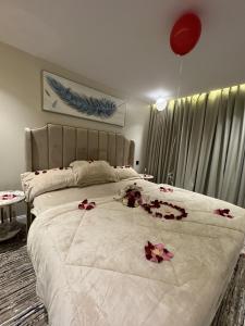 a bedroom with a large bed with flowers on it at منتجع الرتاج الريفي in Buraydah