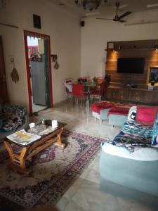 a living room with a couch and a table at Alok Premanand's House in Raipur