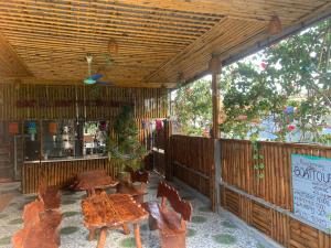 a patio with tables and chairs in a restaurant at Cat Ba Rustic Homestay in Cat Ba