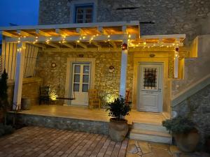 a porch with lights on a stone house at Kranidi House. in Kranidi +40 photos