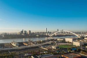 a view of a city with a river and a bridge at Four-Bedroom Apartment, The Bund View with Branded Appliances in Shanghai