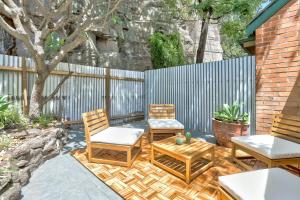 two chairs and a table on a patio at 2 Bedroom House Darling Harbour Kent St in Sydney