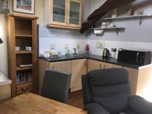 uma cozinha com um lavatório, uma mesa e cadeiras em 1 Bed in Dawlish Warren WARRE em Cockwood