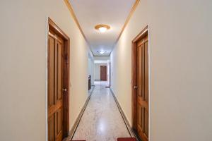 an empty hallway with two doors and a hallway at FabHotel Prini Inn in Manāli