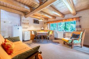 a living room with a couch and a table at Resort 7 Crai - Cabana Calinet in Zărneşti