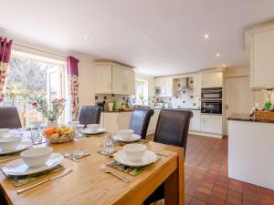 a kitchen and dining room with a wooden table and chairs at 4 Bed in Bakewell PK911 in Bakewell