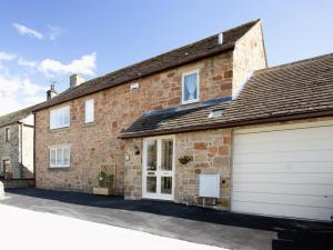 a brick house with a garage in front of it at 4 Bed in Bakewell PK911 in Bakewell
