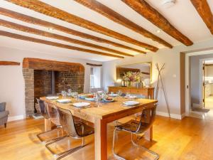 a dining room with a large wooden table and chairs at 4 Bed in Umberleigh 50154 in Burrington