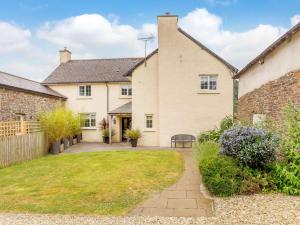 an exterior view of a house with a yard at 4 Bed in Umberleigh 50154 in Burrington