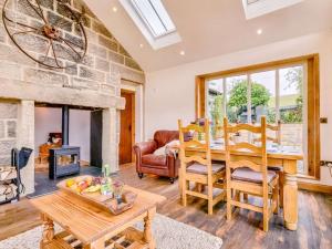 a living room with a table and a fireplace at 2 Bed in Rothbury 88270 in Rothbury