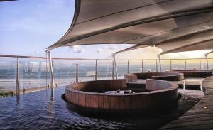 a hot tub with a view of the beach at Double - Six, Luxury Hotel - Seminyak in Seminyak