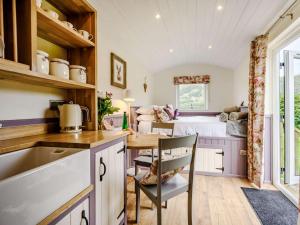a kitchen with a table and a bed in a room at 1 Bed in Patterdale 89510 in Deepdale