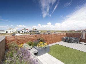 a backyard with a wooden fence and a garden at 4 Bed in Westward Ho 89017 in Westward Ho