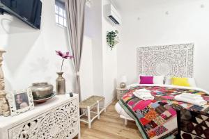 a white bedroom with a bed and a table at Small & cozy near Piazza Navona in Rome