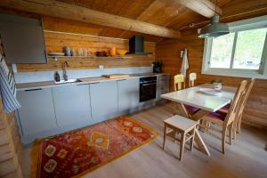 a kitchen and dining room with a table and chairs at Åndalsnes Hytteutleie in Åndalsnes