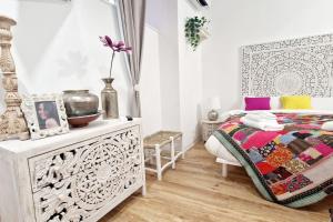 a white bedroom with a bed and a dresser at Small & cozy near Piazza Navona in Rome