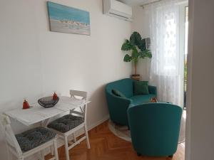 a living room with a table and two chairs and a table and a tablektop at Apartment Lea in Dubrovnik