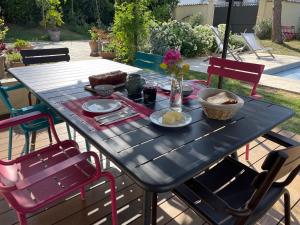 a black table with plates of food on it at Suite 671 in Reyrieux