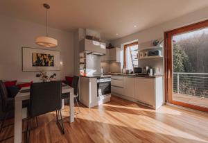 a kitchen and dining room with a table and a window at Nina´s Home in Gablitz +14 photos