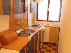 a small kitchen with a sink and a stove at Sunflower Apartment in Opatija