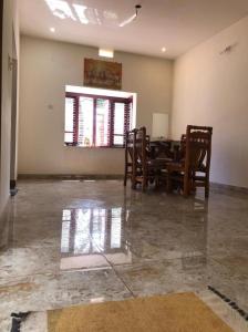 a dining room with a table and chairs at Adis home- with waterfalls in Kalasa