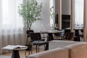 a dining room with tables and chairs and a couch at OldTown&River View Hoffmann B14 in Riga