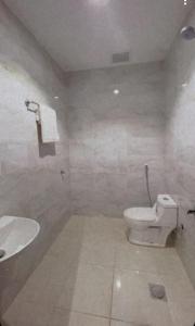 a bathroom with a white toilet and a sink at شقق السلام المخدومة in Al Madinah