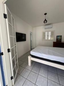 Ένα ή περισσότερα κρεβάτια σε δωμάτιο στο Casa em Juquehy com piscina a 100 metros da praia