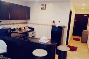 a kitchen with a counter with a cake on it at Studio Luxury Apartment by Mamzar Beach in Dubai