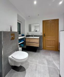 a bathroom with a toilet and a sink at Haus Korjässer in Löf