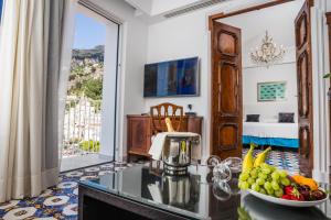 a kitchen with a table with a bowl of fruit at Hotel Marina Riviera in Amalfi